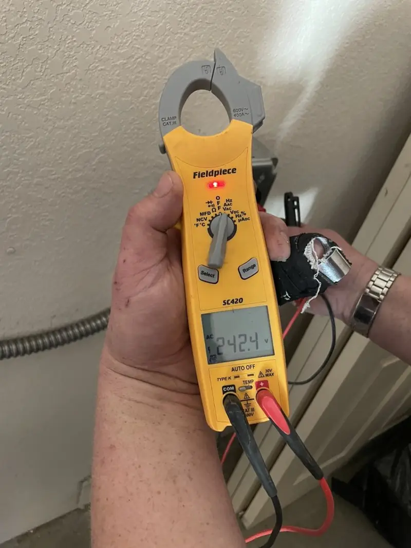Voltage testing with clamp meter during Outlet Installation in Caledonia